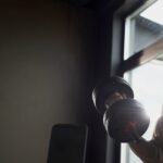 Senior,Caucasian,Man,Lifting,Dumbbell,In,Gym,,Showing,Muscular,Arms