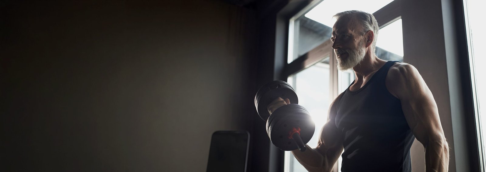Senior,Caucasian,Man,Lifting,Dumbbell,In,Gym,,Showing,Muscular,Arms