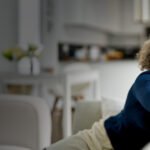 Happy,Middle,Aged,Woman,Sitting,On,Comfy,Sofa,In,Living