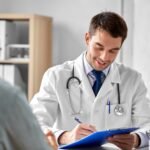 doctor with clipboard and male patient at hospital
