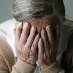 1140-alzheimer-myths-woman-hiding-face-esp